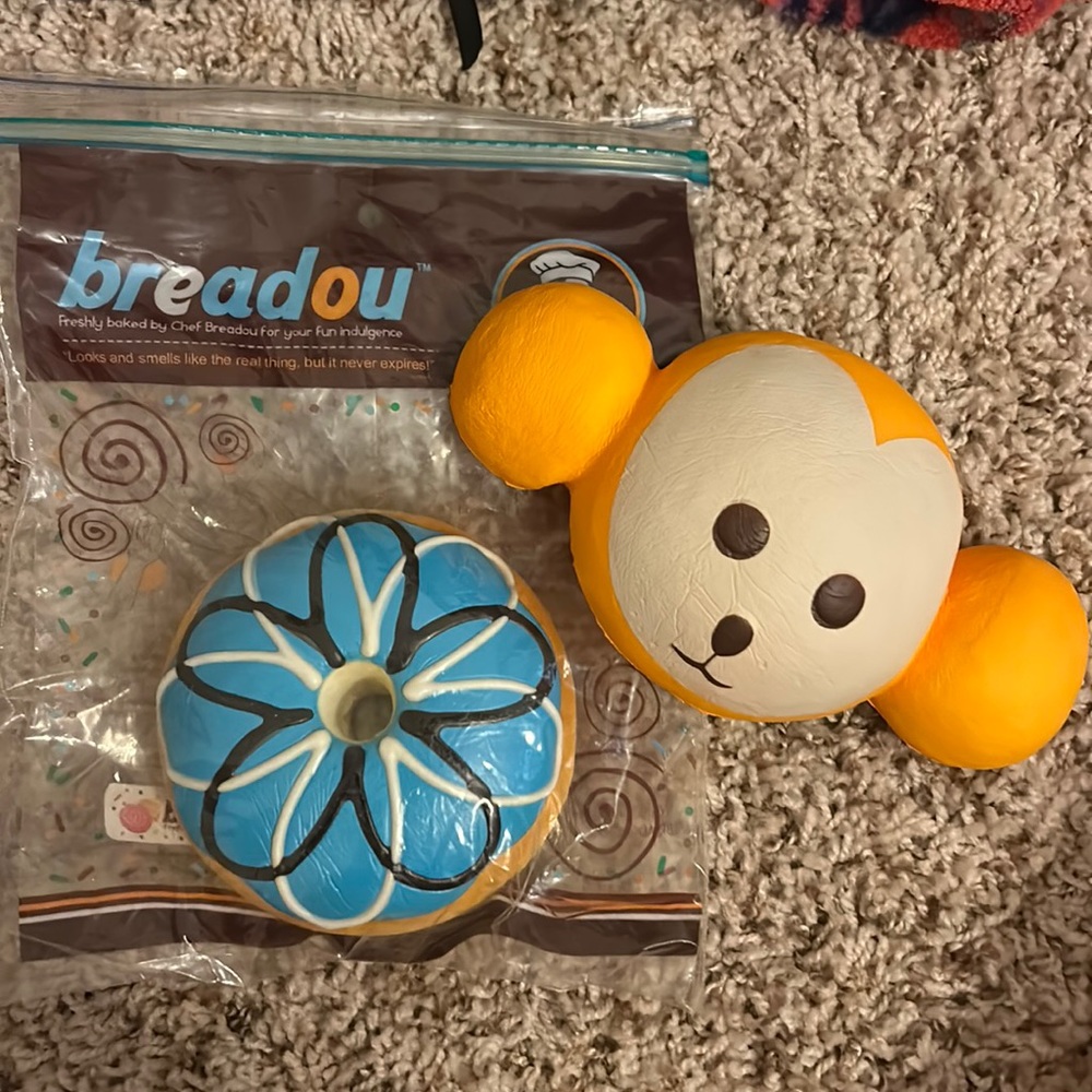 one breadou donut squishy and a monkey head squishy